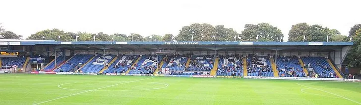 Một góc sân Gigg Lane, cho thấy sự hòa quyện giữa khán đài và sân cỏ